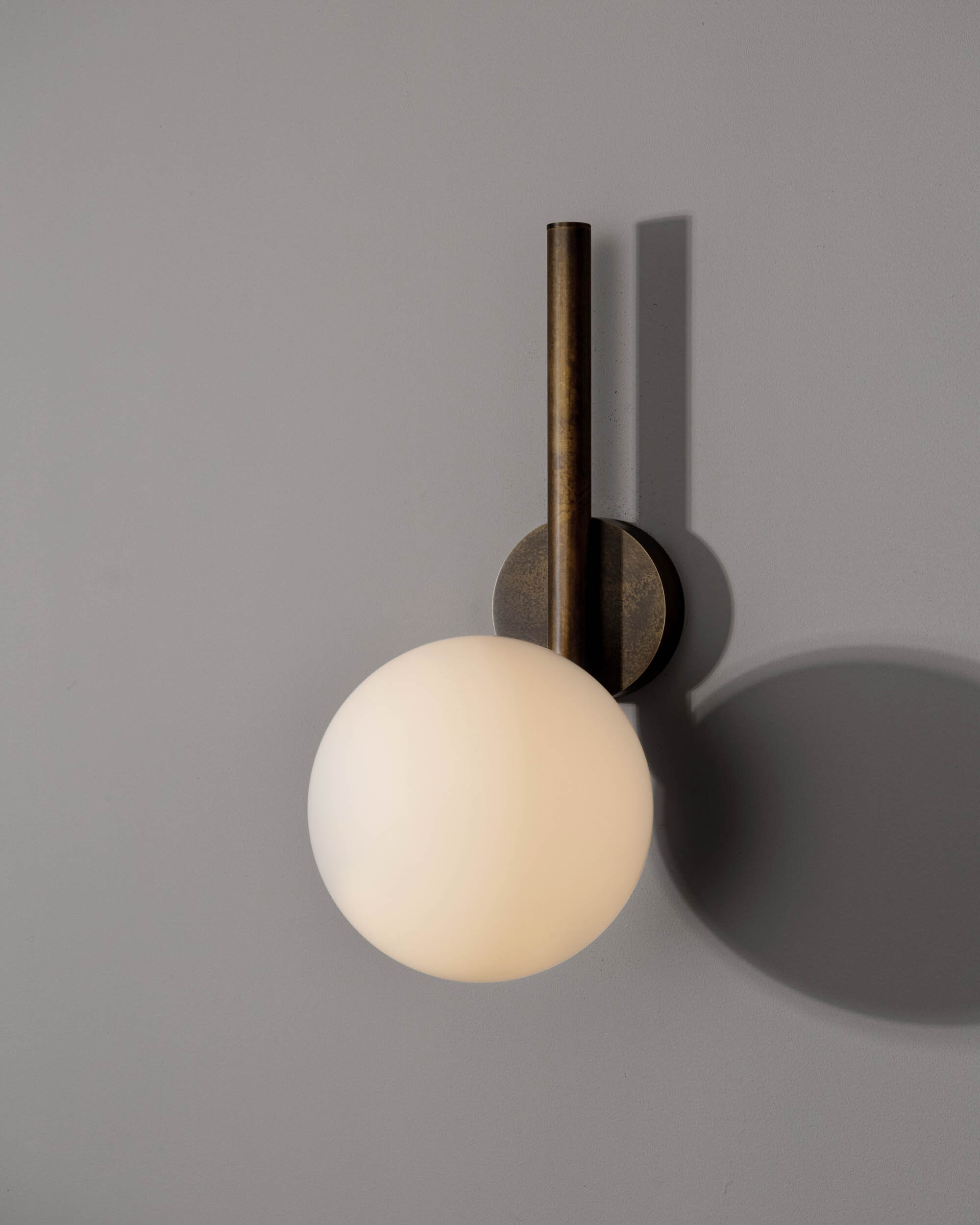 Tubular MD brass and glass Wall Sconce in classic bronze finish handcrafted by Schwung