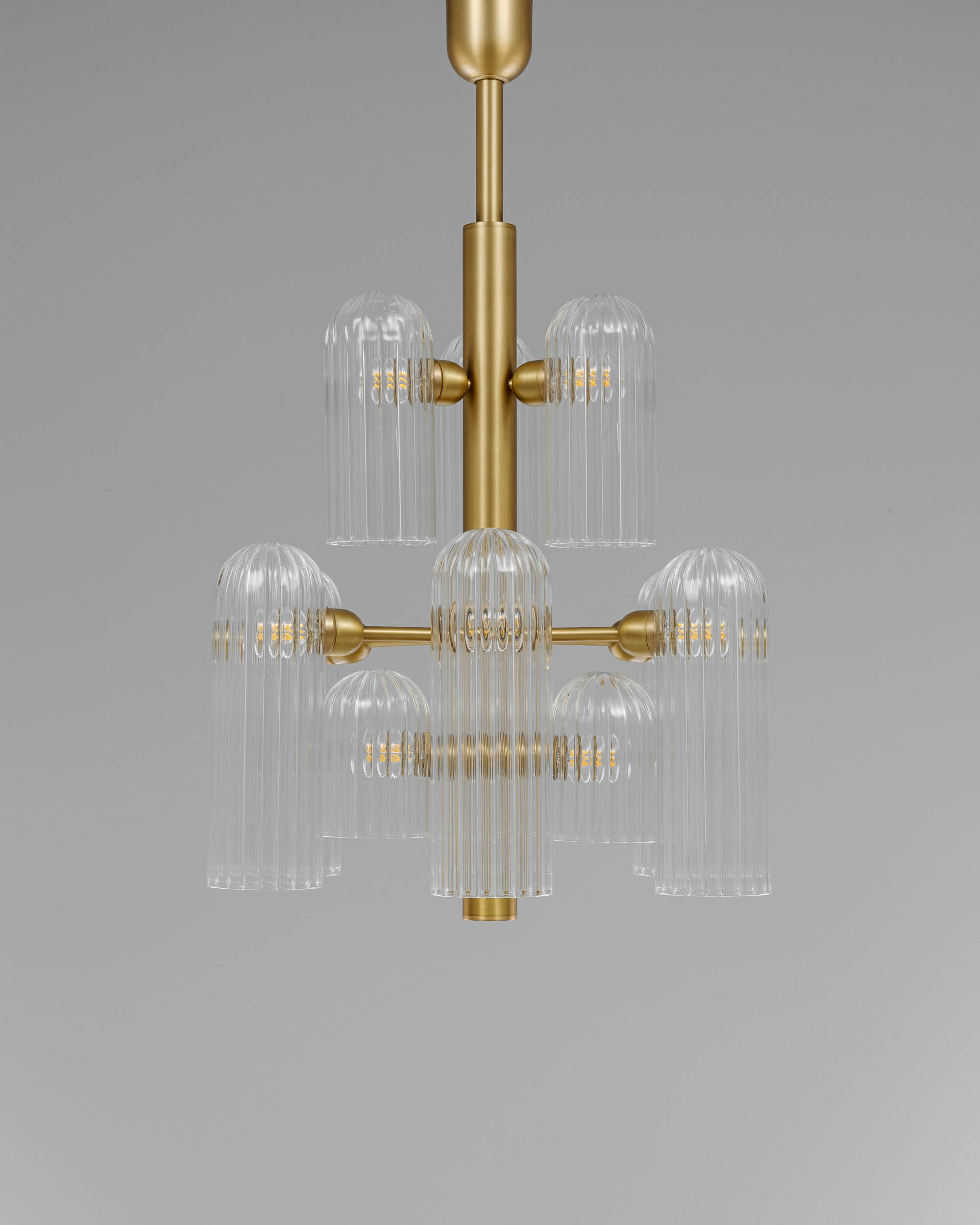 Odyssey 12 brass and glass Chandelier in lacqured burnished brass finish handcrafted by Schwung