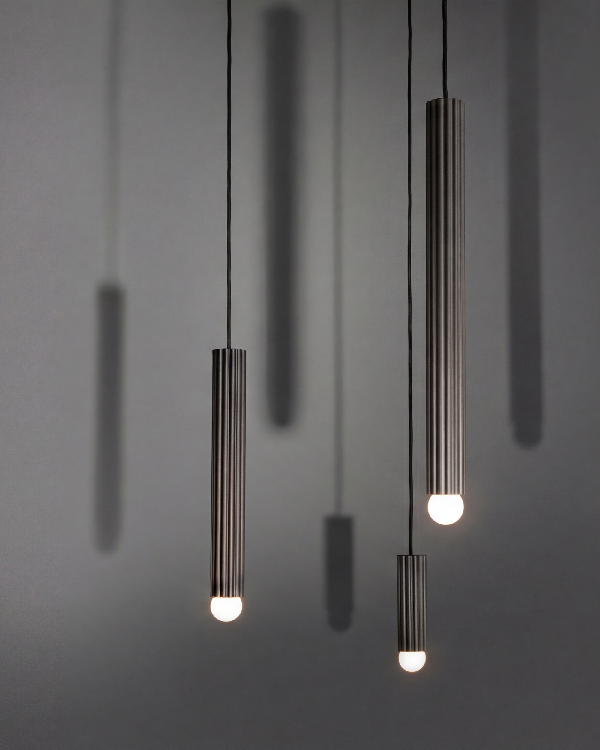 Vesta pendants in various sizes in classic bronze finish, handcrafted by Schwung.