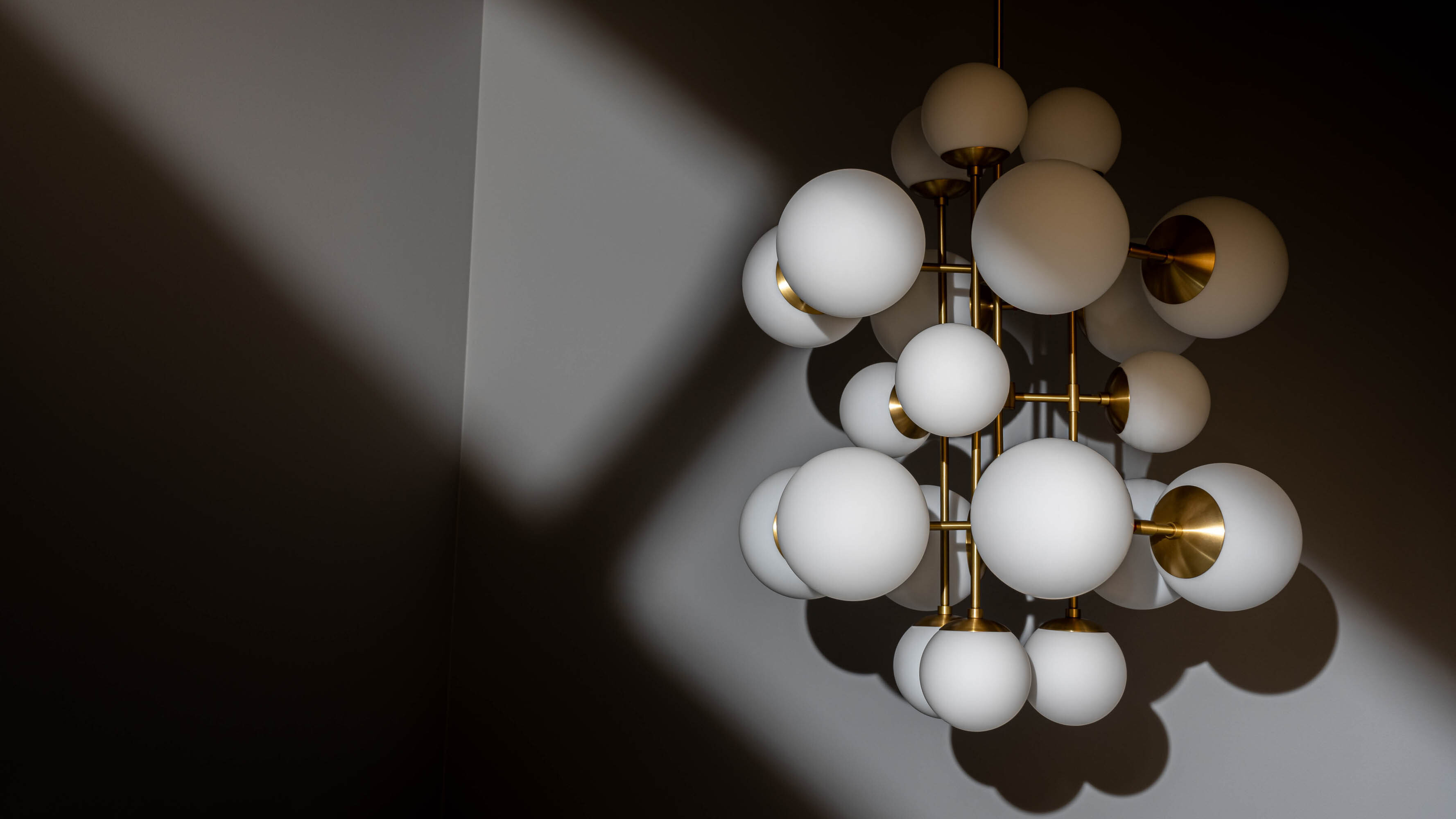 Glow brass and glass Chandelier in Lacquered Burnished Brassfinish handcrafted by Schwung