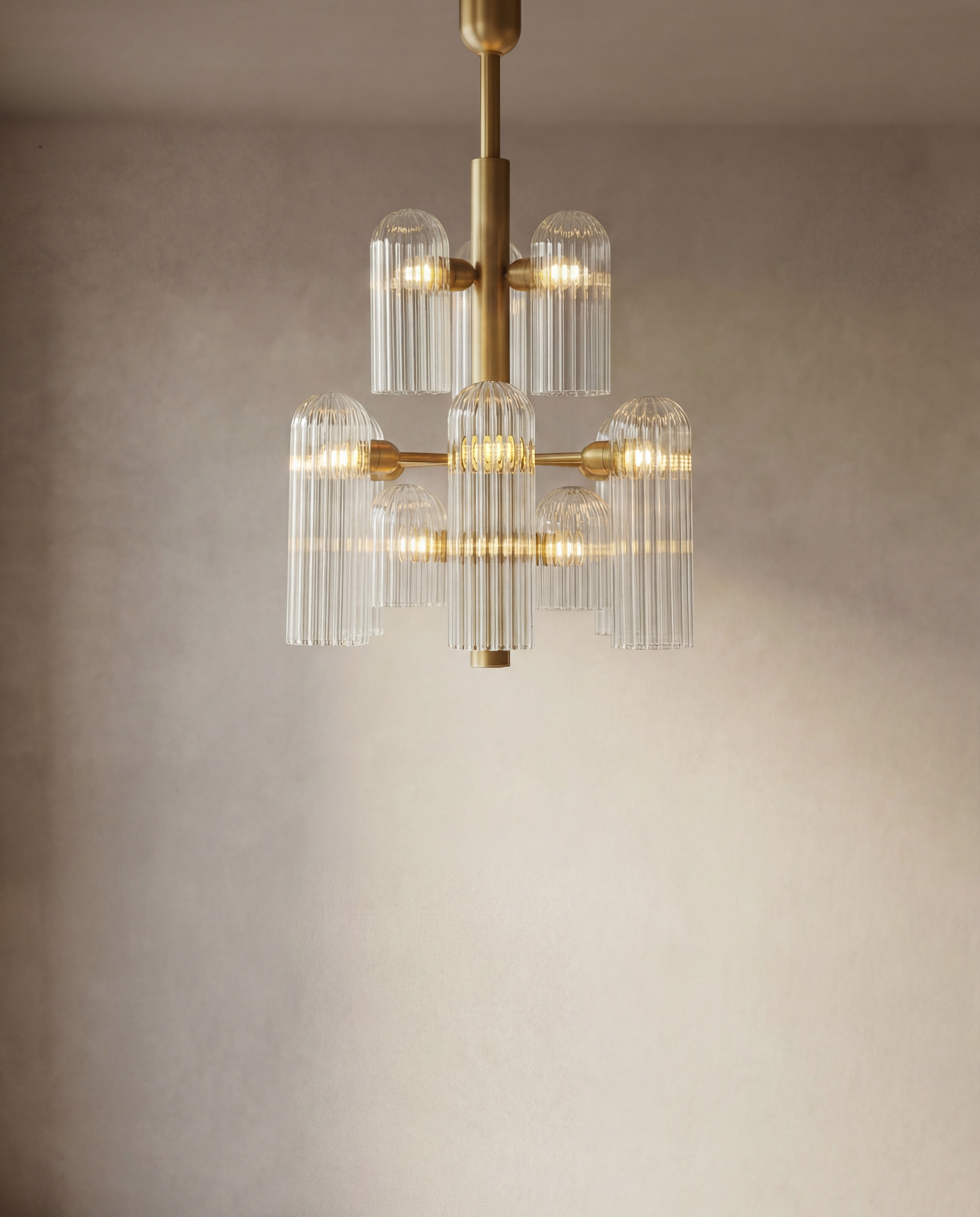 Odyssey 12 brass and glass Chandelier in lacqured burnished brass finish handcrafted by Schwung