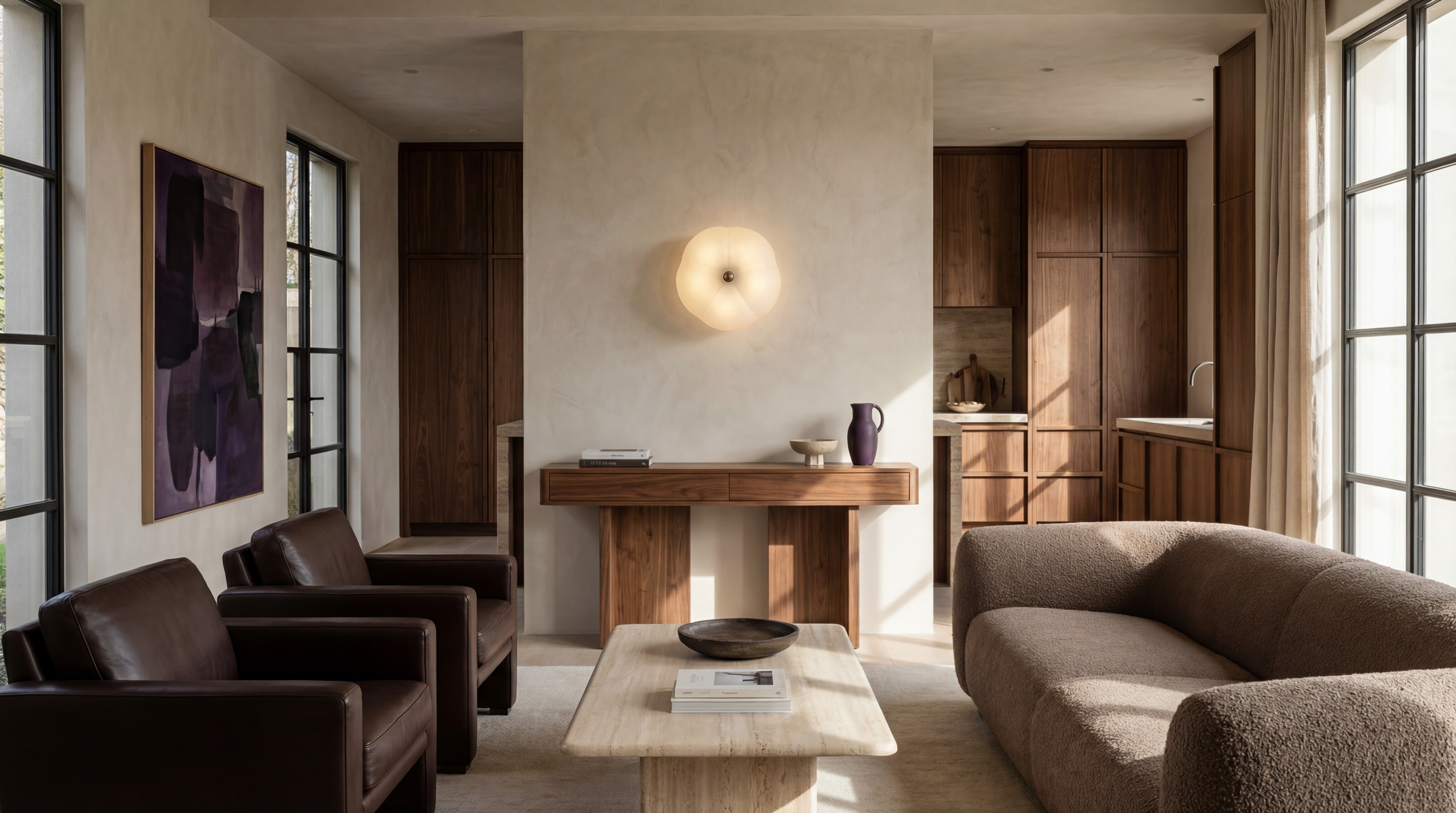Hana MD brass and glass wall sconce/flush mount in a Classic Bronze finish, handcrafted by Schwung, mounted as a wall sconce above a console table in a living room to subtly illuminate the space and serve as a decorative accent.