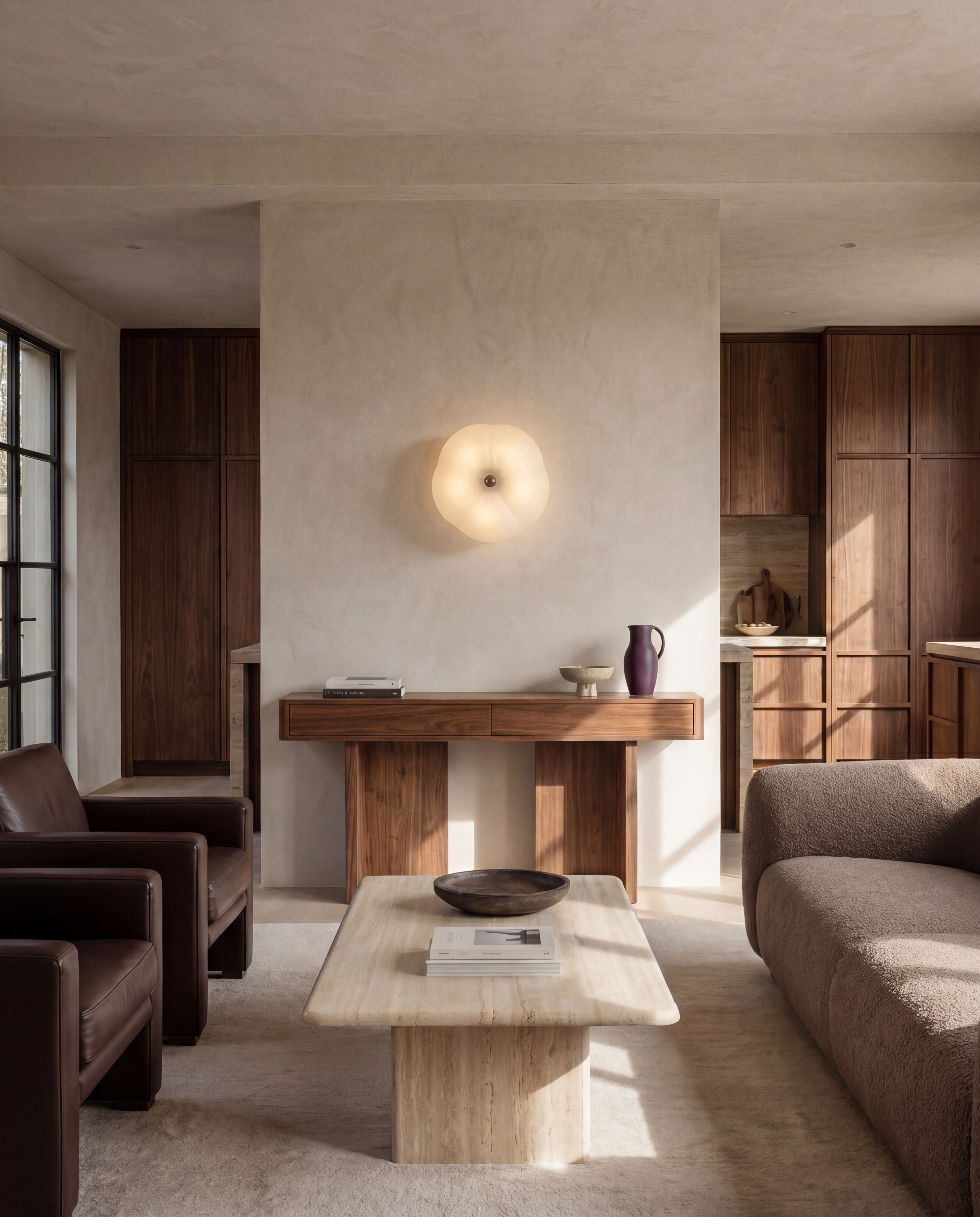 Hana MD brass and glass wall sconce/flush mount in a Classic Bronze finish, handcrafted by Schwung, mounted as a wall sconce above a console table in a living room to subtly illuminate the space and serve as a decorative accent.