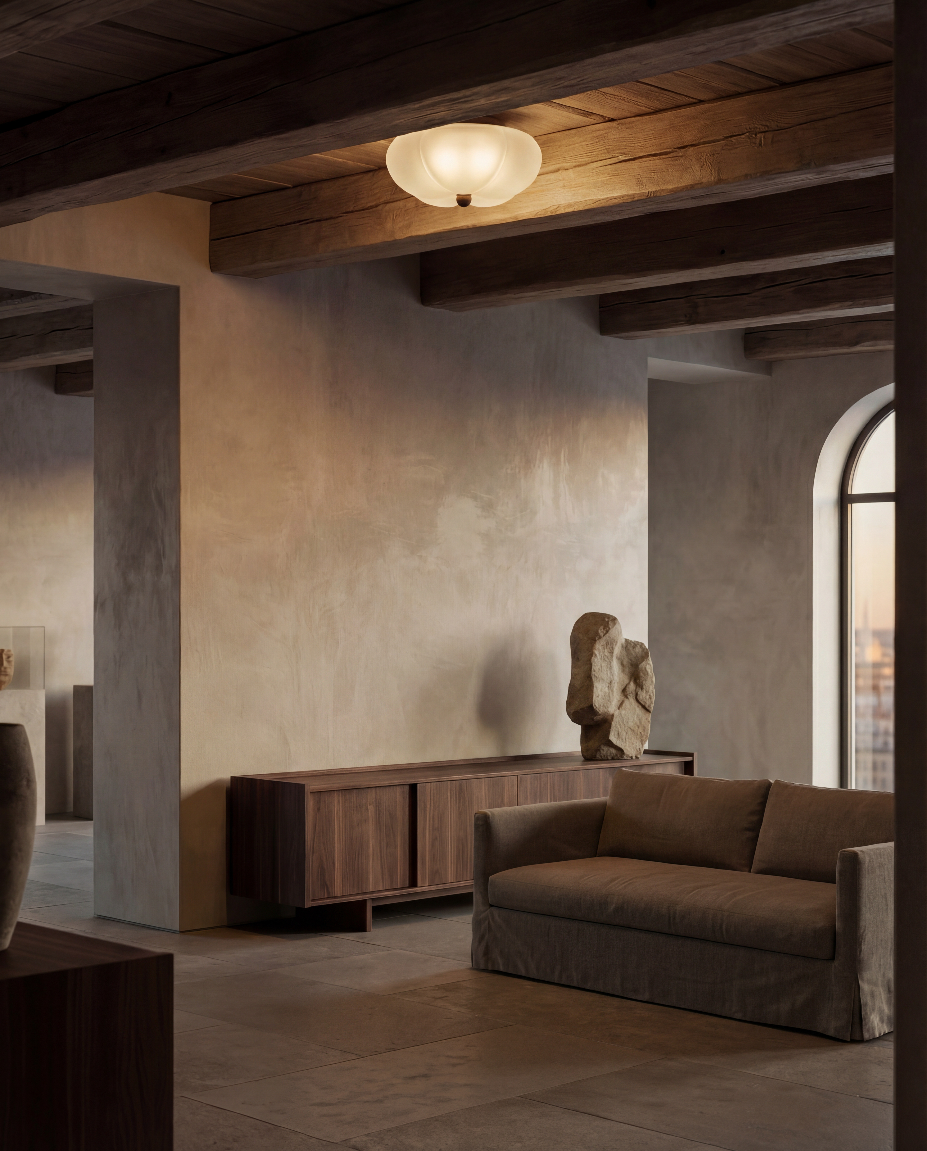 Hana MD brass and glass flush mount in a Classic Bronze finish, handcrafted by Schwung, installed on the ceiling above sofas in a living room.