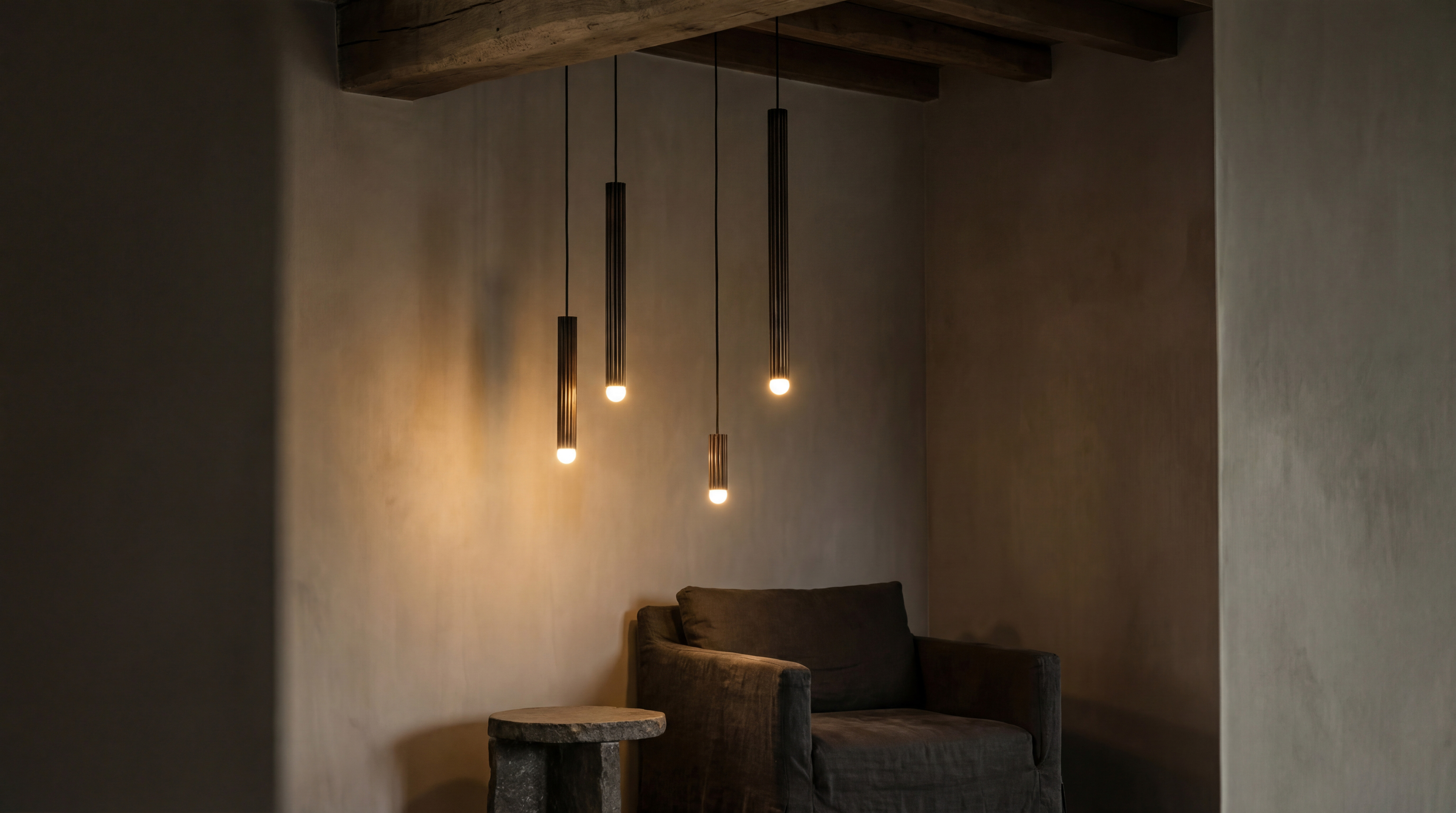 Vesta Single pendants in various sizes, suspended in a warm, atmospheric interior with refined architectural details by Schwung.