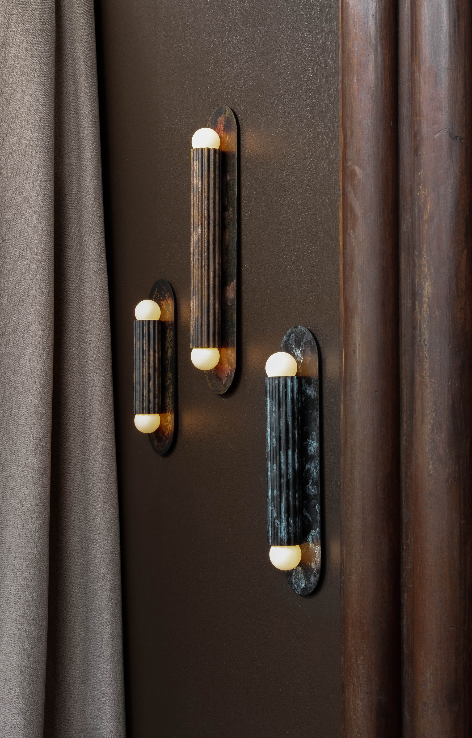 Vesta MD, LG and XLG brass and glass wall sconces in a moody luxury interior by Schwung.