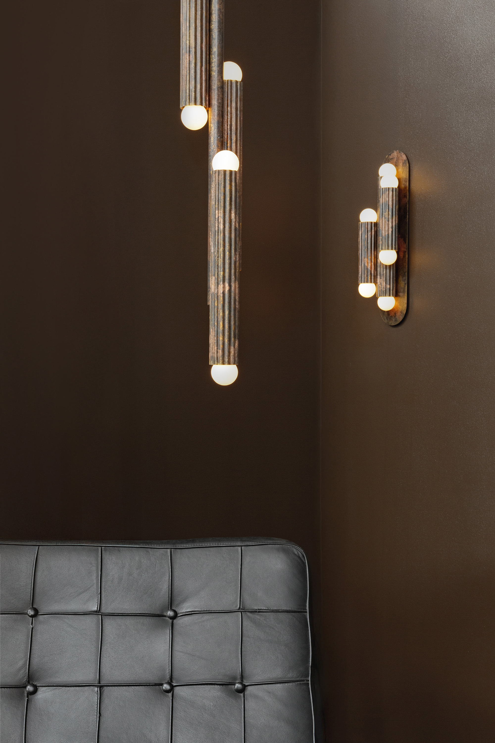 Vesta Triple 2 wall sconce and Vesta pendant in an elegant, softly lit interior with refined brass details by Schwung.
