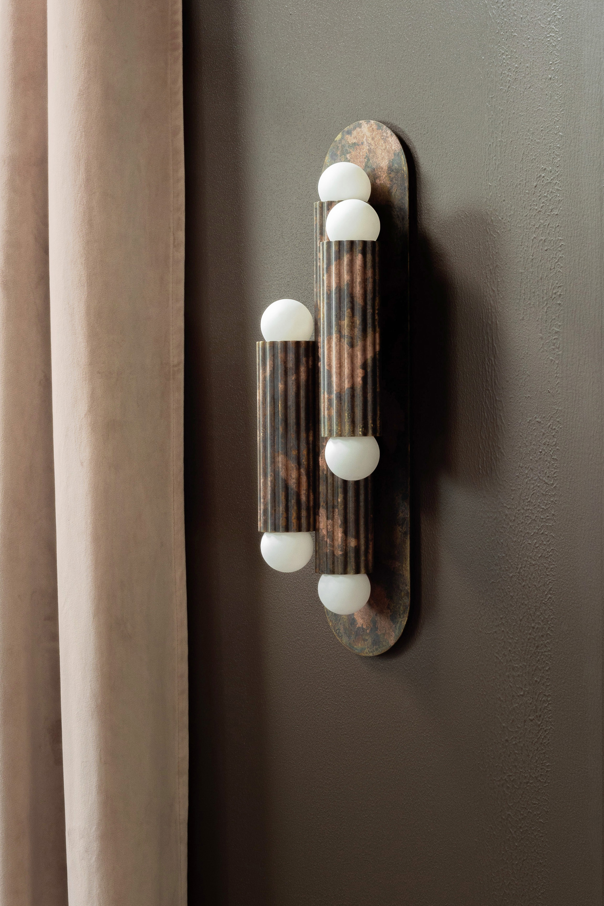Vesta Triple 2 wall sconce and Vesta pendant in an elegant, softly lit interior