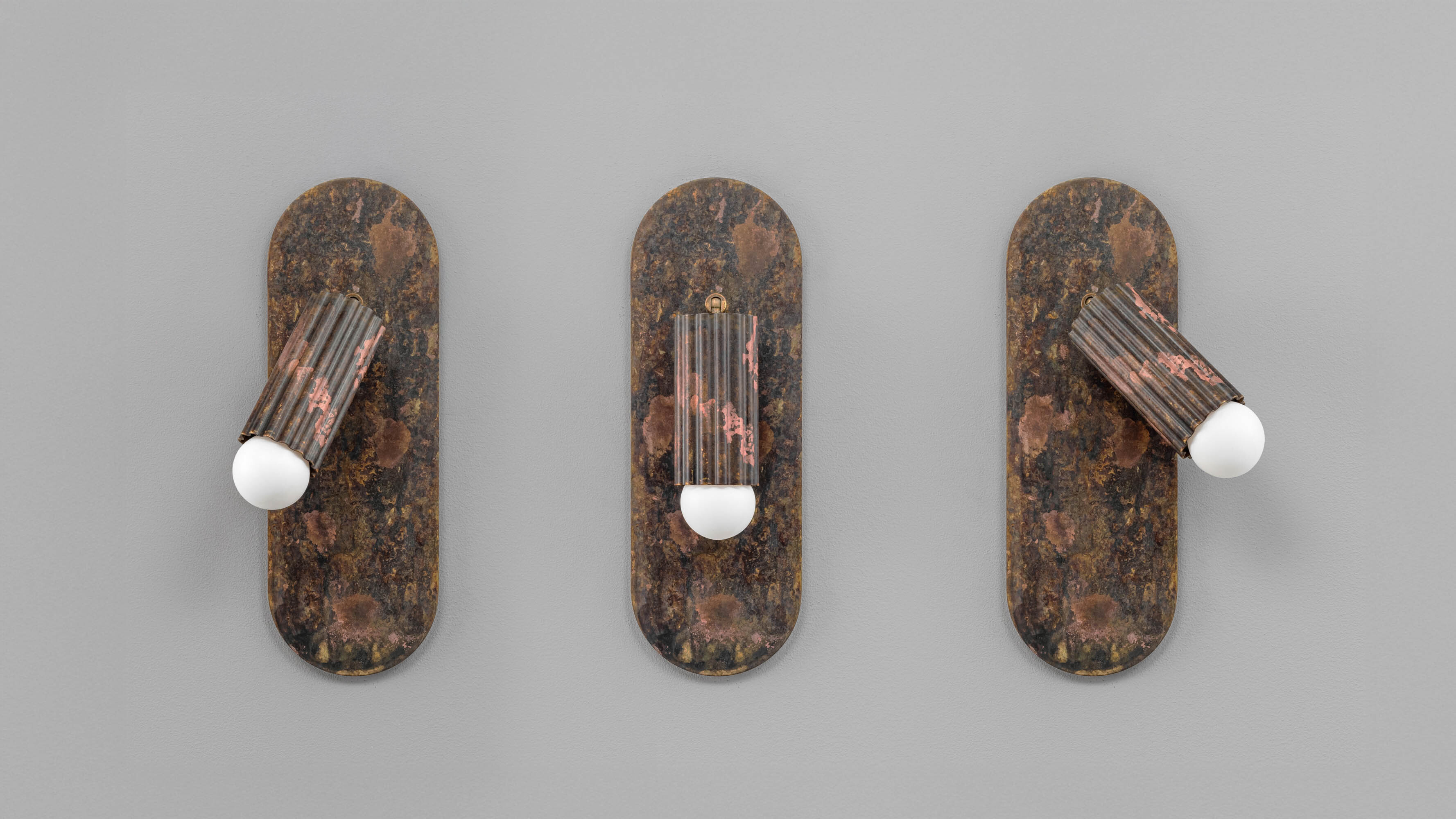 Vesta Flex wall sconces in rose ash finish, handcrafted in brass and glass by Schwung.