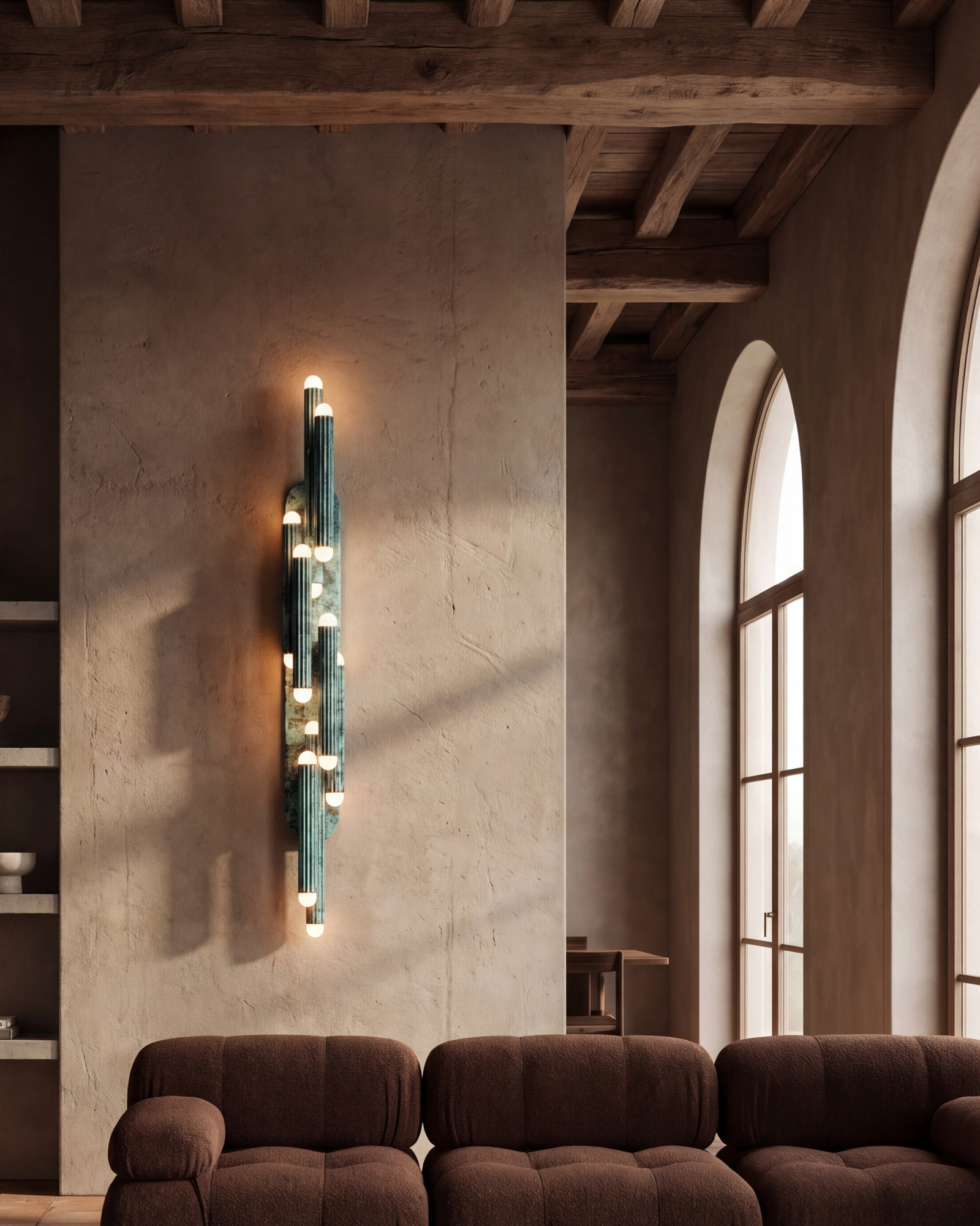 Vesta Legion LG wall sconce in verdigris ash finish, illuminating a refined architectural interior by Schwung.