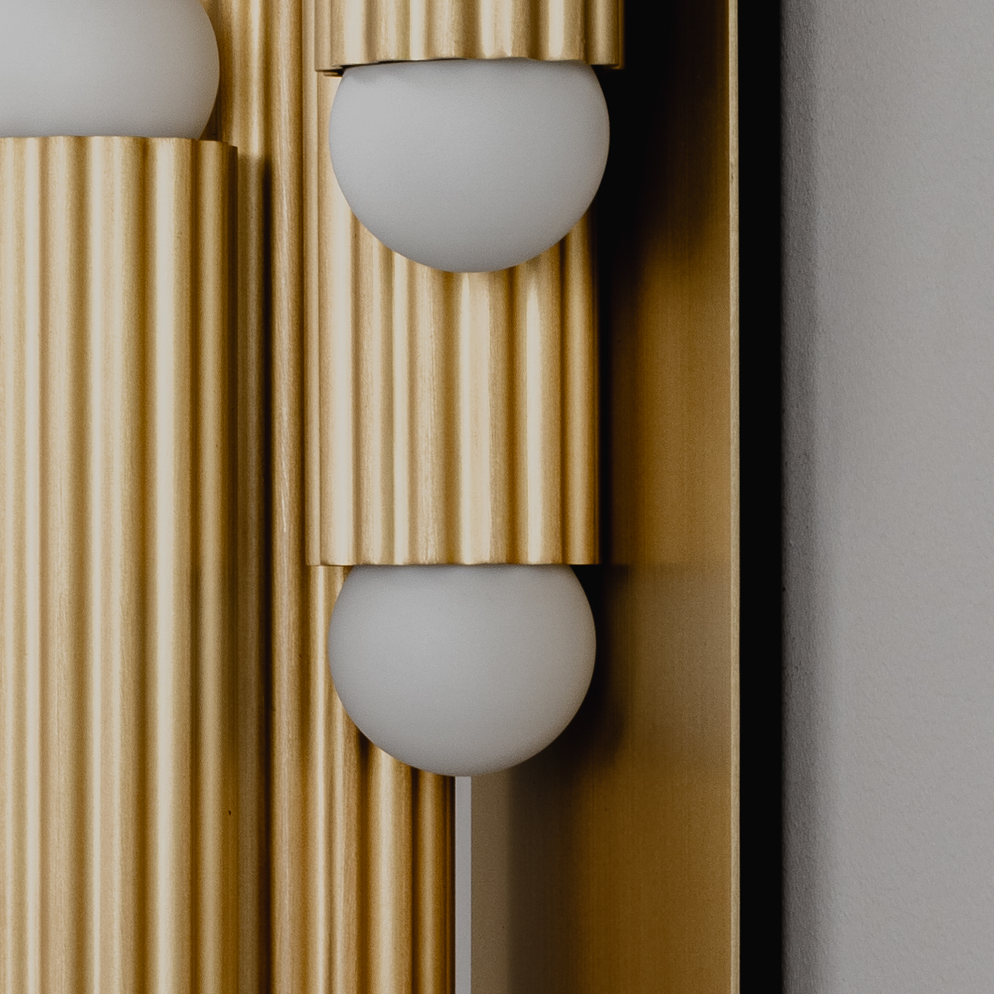 Close-up of brass elements in Vesta Legion MD Wall Sconce/Flush Mount showcasing the lighting detail by Schwung.