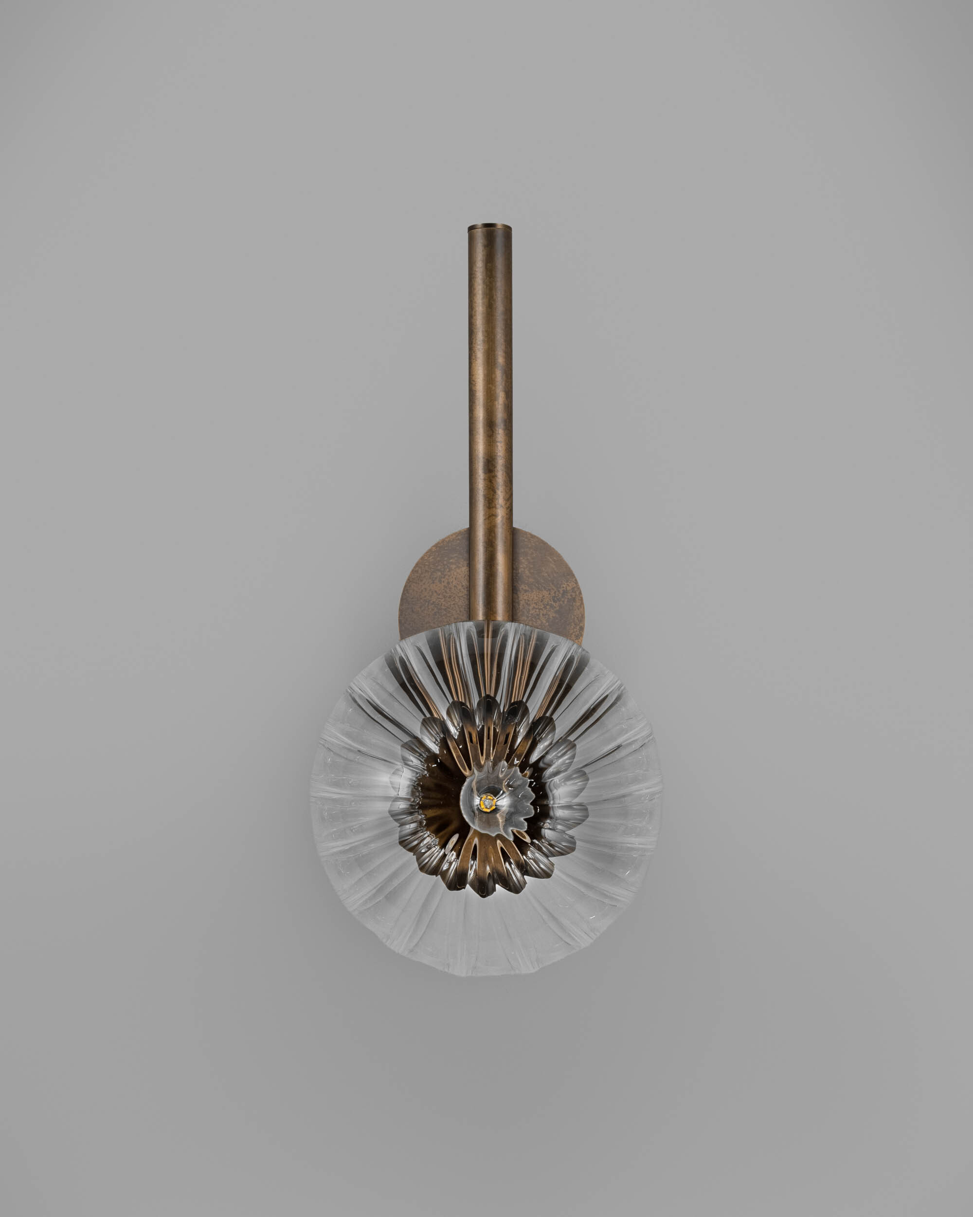 Tubular MD brass and glass wall sconce in a Classic Bronze finish with an ribbed glass shade, handcrafted by Schwung.