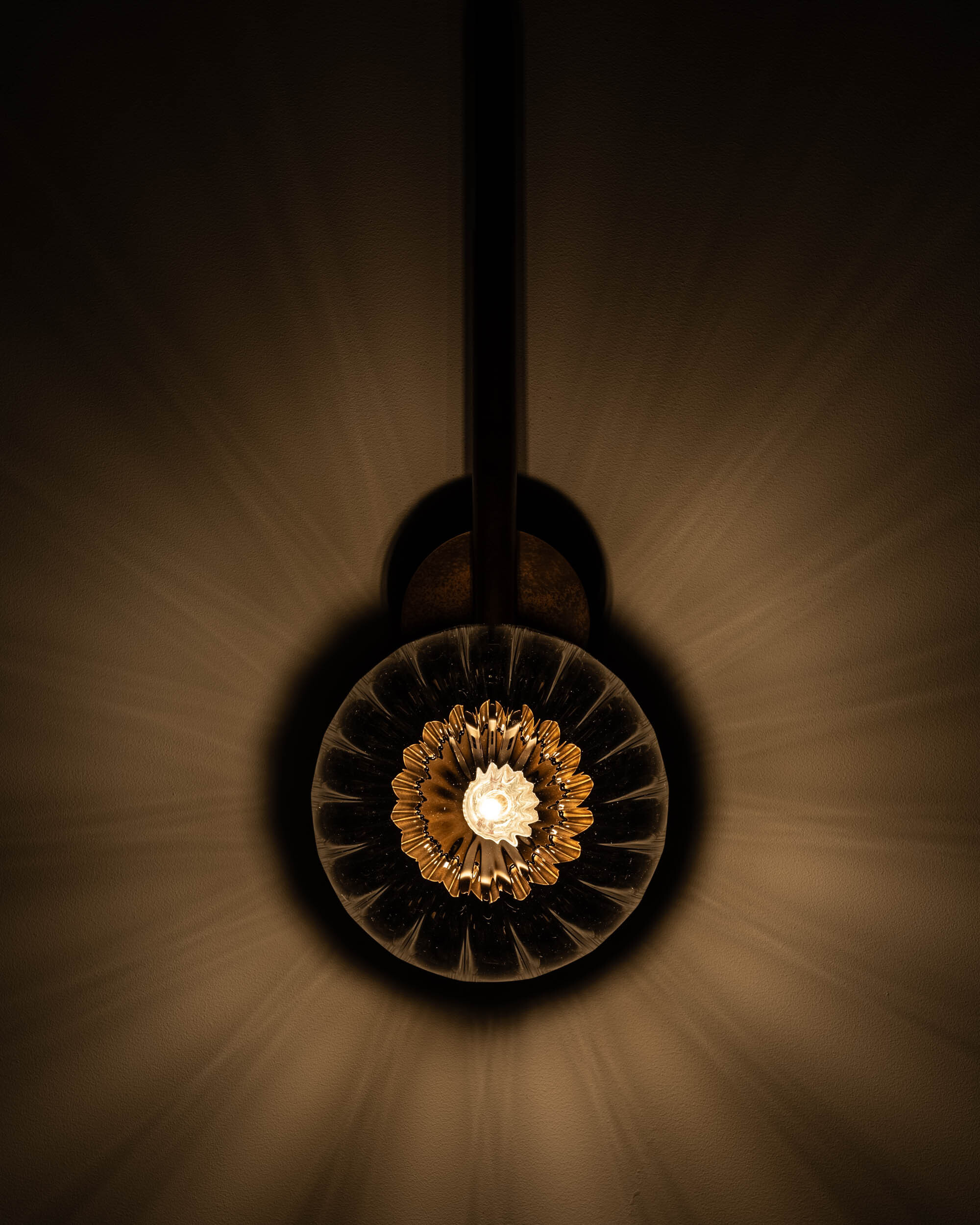 Tubular MD brass and glass wall sconce in a Classic Bronze finish with an ribbed glass shade, handcrafted by Schwung.