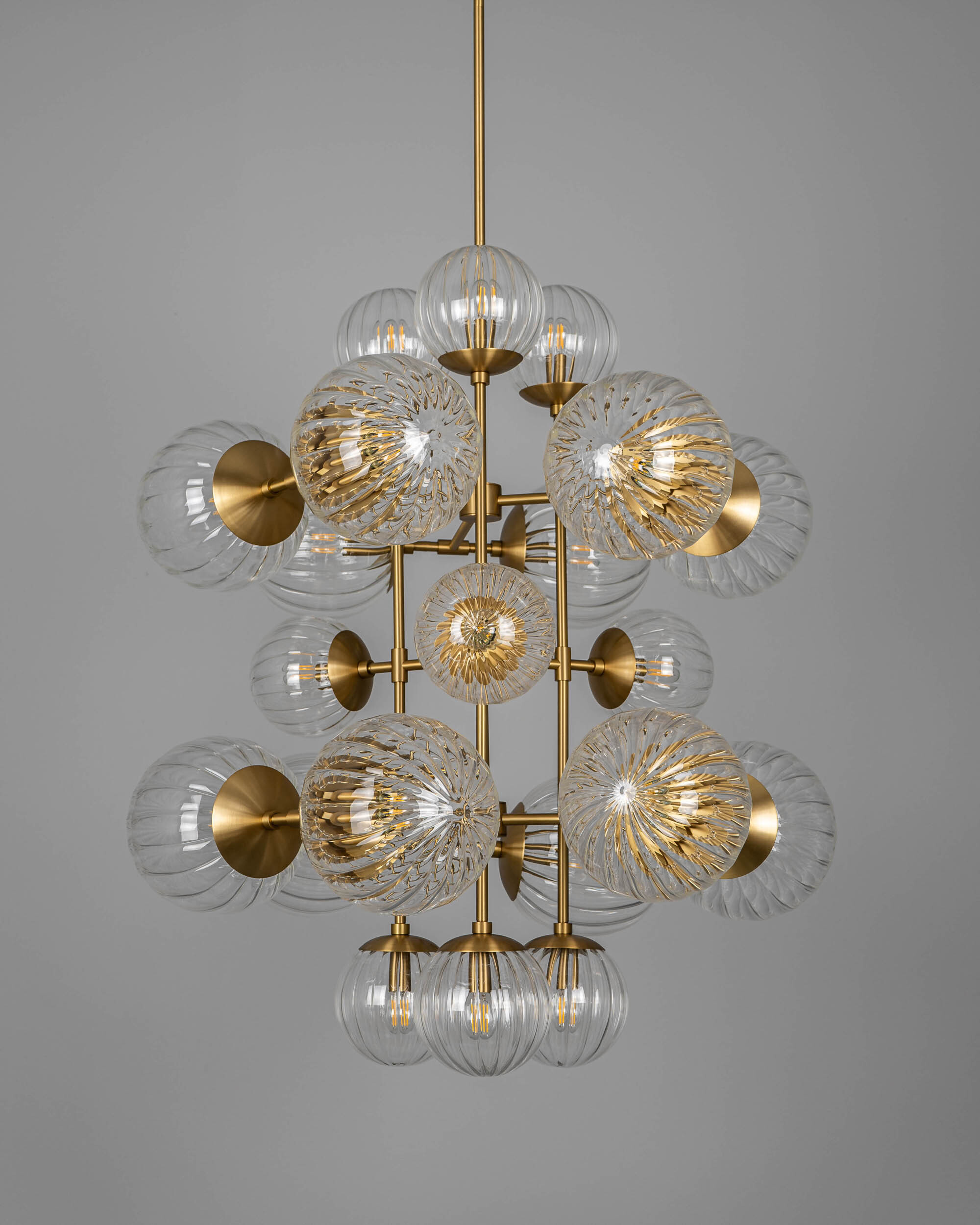 Glow brass and glass Chandelier in Lacquered Burnished Brassfinish handcrafted by Schwung