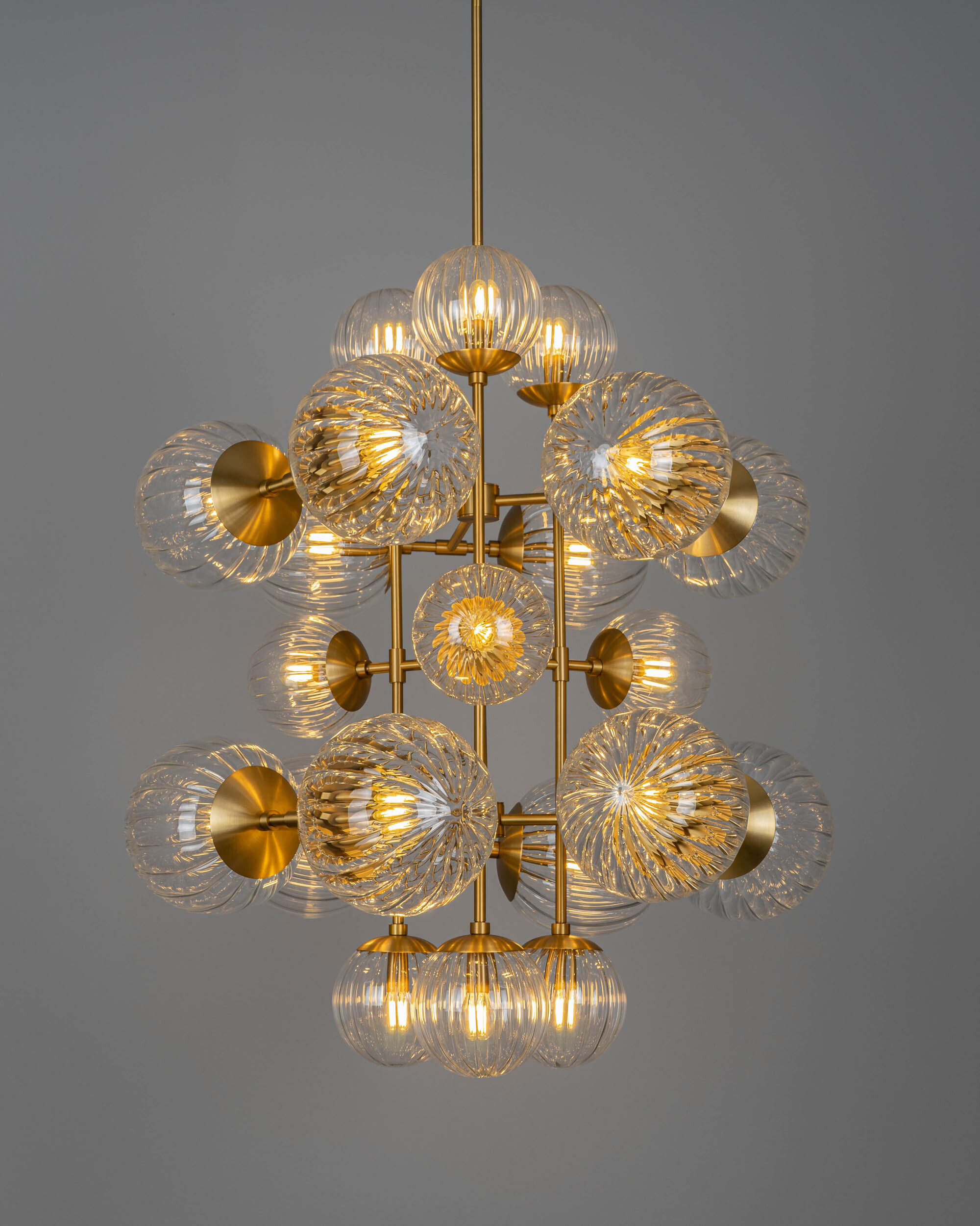 Glow brass and glass Chandelier in Lacquered Burnished Brassfinish handcrafted by Schwung