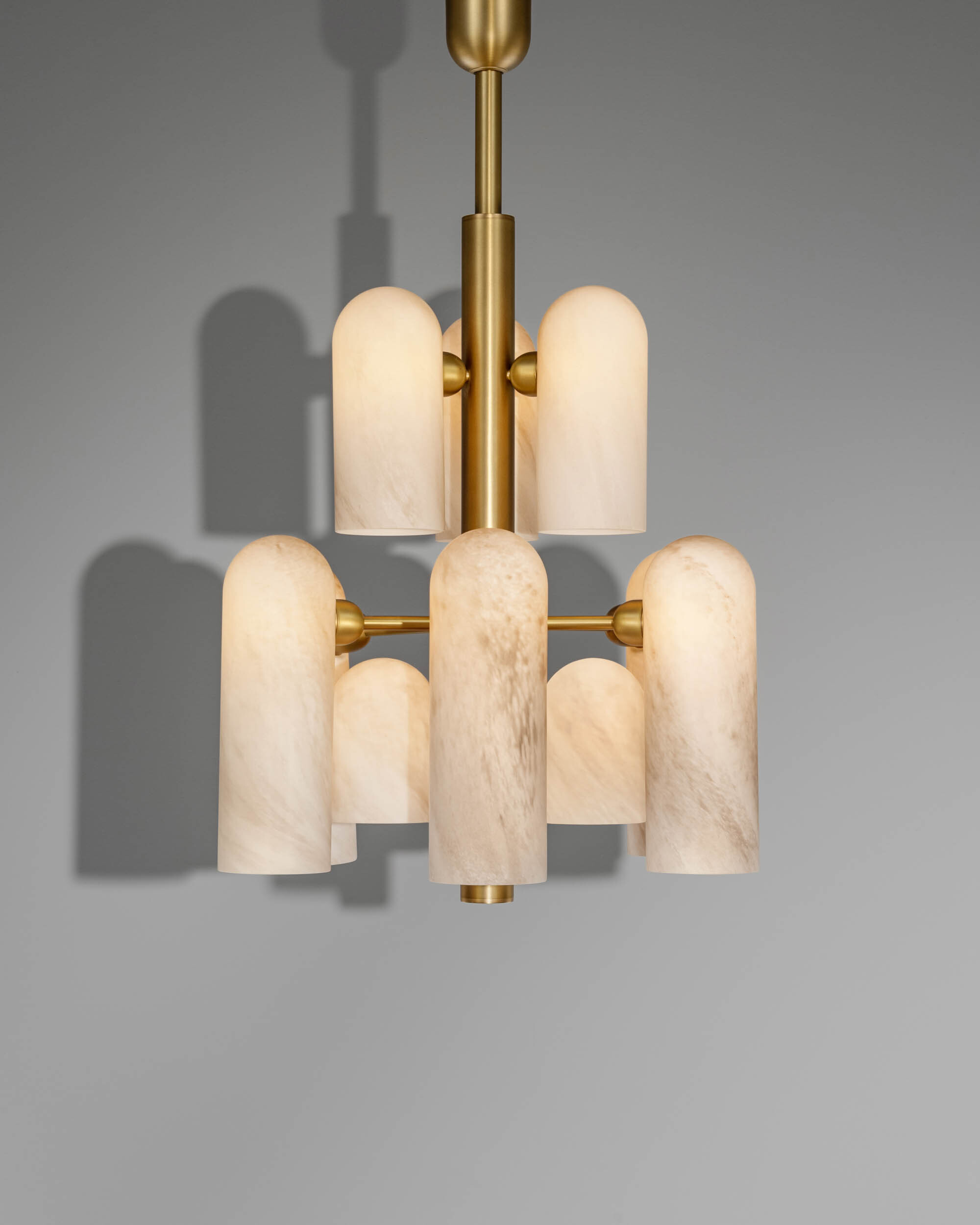 Odyssey 12 brass and glass Chandelier in lacqured burnished brass finish handcrafted by Schwung